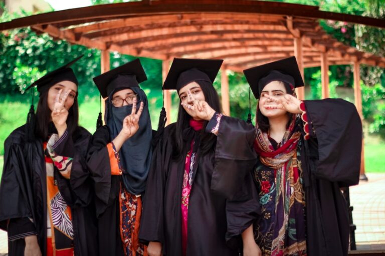 a group of people in graduation gowns posing for a picture