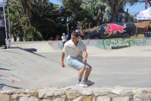 Young man skateboarding at a sunny skatepark