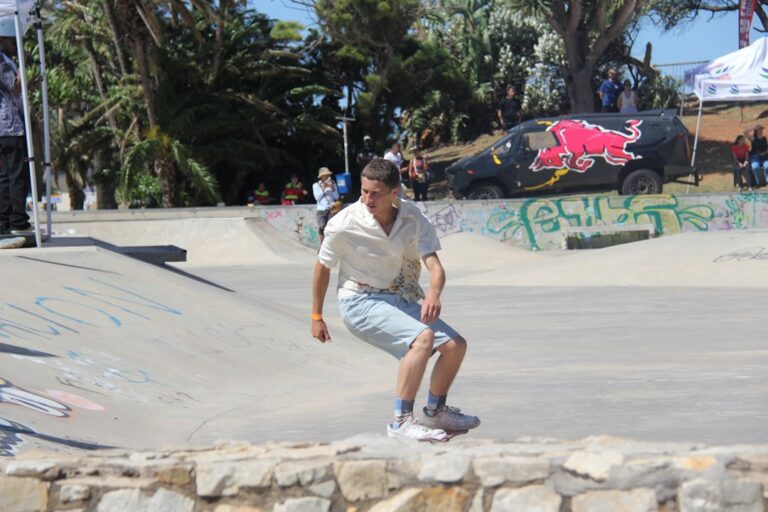 Young man skateboarding at a sunny skatepark