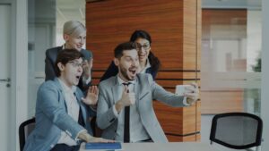 Team celebrates success while taking a selfie