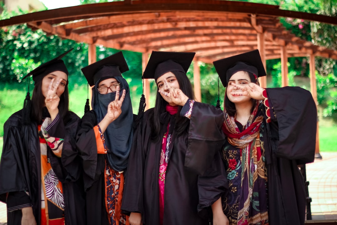 a group of people in graduation gowns posing for a picture
