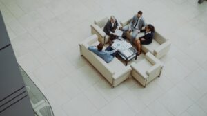 Business people meeting on sofas in a modern lobby.