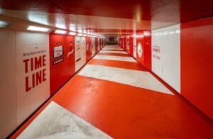 Red and white striped hallway with timeline graphics