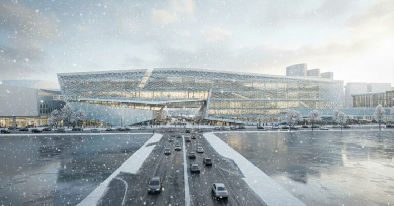 Modern building with cars on a snowy road