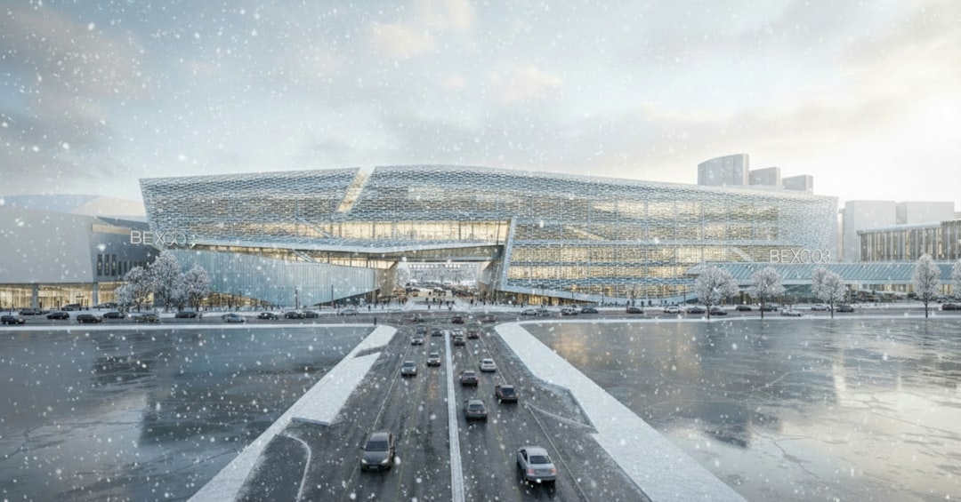Modern building with cars on a snowy road
