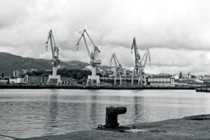 Industrial harbor with large cranes and calm water
