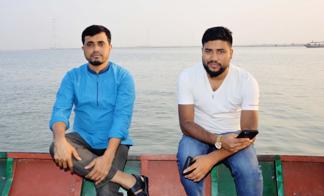 a couple of men sitting on top of a boat