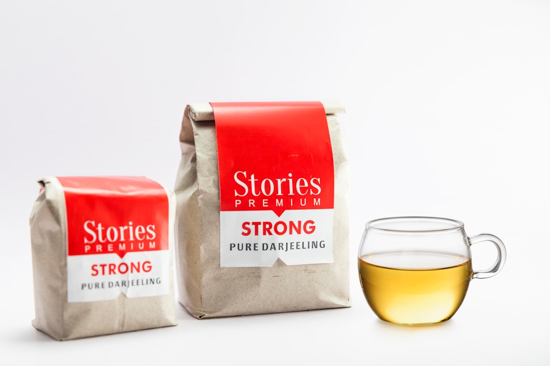 two bags of tea next to a cup of tea