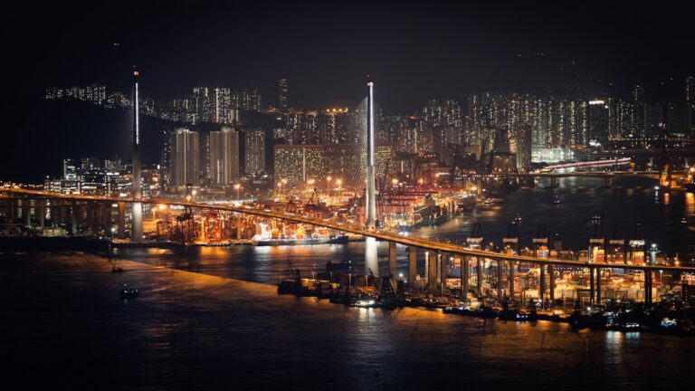 Vibrant cityscape with illuminated bridge at night