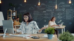 People working in a modern office with chalk drawings.