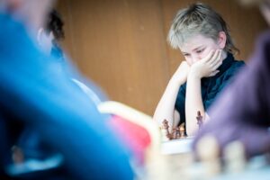 Young person concentrating while playing chess