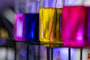 Colorful liquids in laboratory beakers on rack