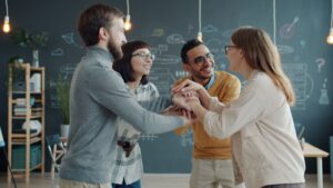 Diverse team celebrates success with a huddle.