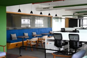 Modern office space with blue seating and desks