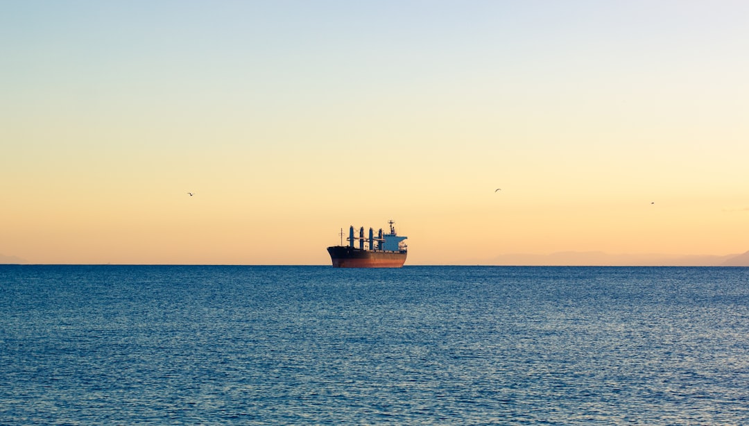 A large cargo ship sailing across a large body of water
