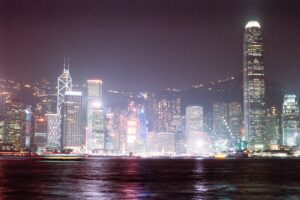 Vibrant cityscape with illuminated skyscrapers at night.