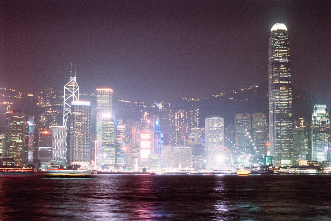 Vibrant cityscape with illuminated skyscrapers at night.