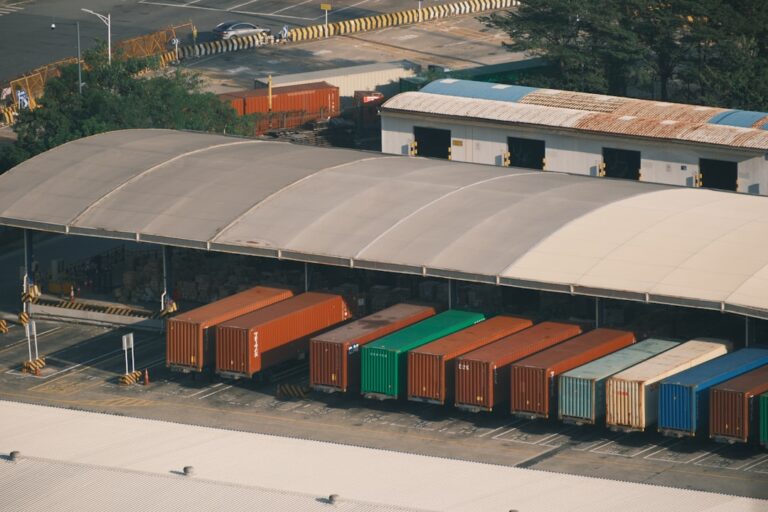 Row of colorful shipping containers under a large awning
