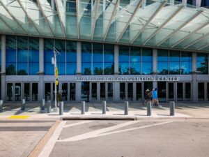 A person walking in front of a large building