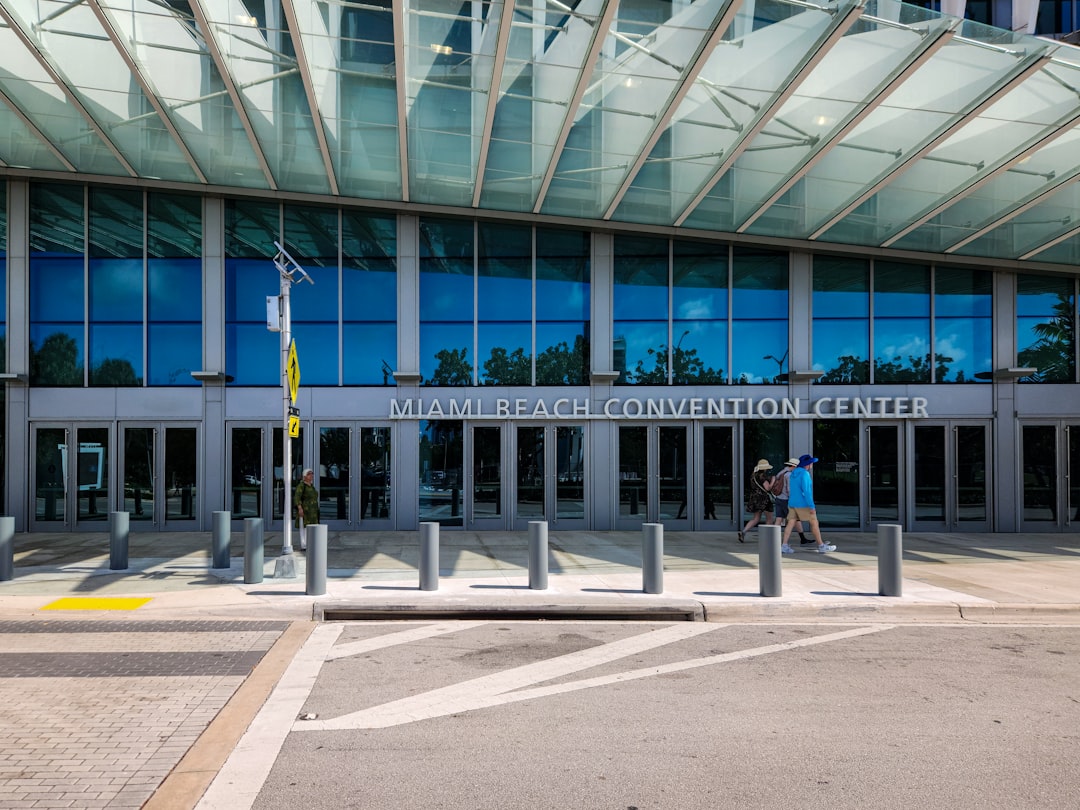 A person walking in front of a large building