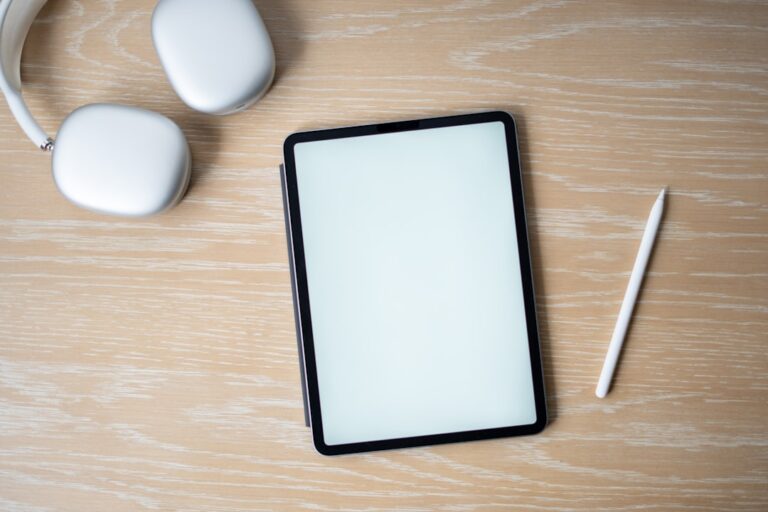 a tablet computer sitting on top of a wooden table