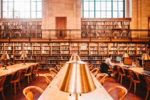 man sitting on chair inside library