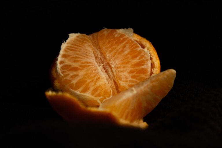sliced orange fruit on black background