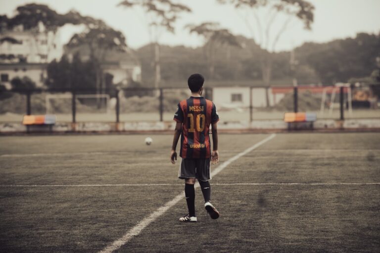 Young soccer player standing on field