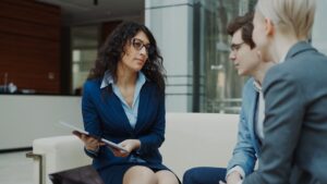 Three professionals in a business meeting discussion