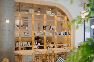 A library-themed cafe with wooden shelves.