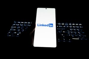 Smartphone displaying linkedin logo with keyboard background