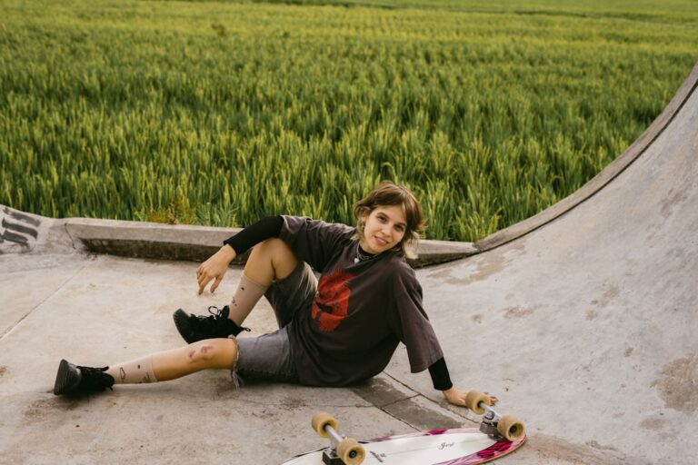 Young person resting on a skateboard ramp