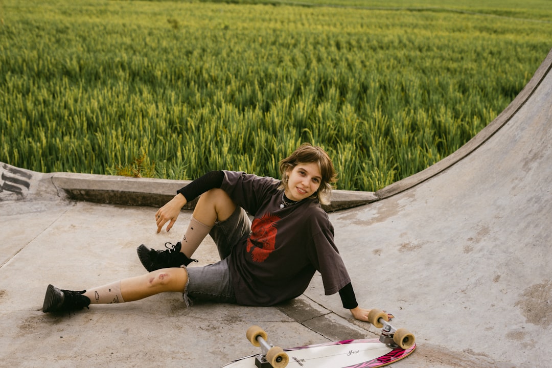 Young person resting on a skateboard ramp