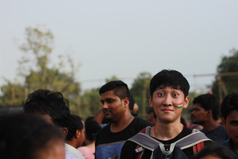 Young man with face paint in a crowd