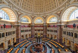 a large ornate building with many arches with Library of Congress in the background