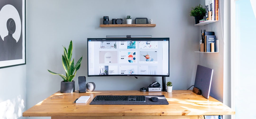 a computer monitor sitting on top of a wooden desk
