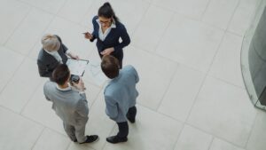 Four business professionals collaborating in a modern office space.