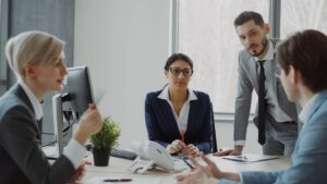 Business professionals collaborating in a modern office meeting.