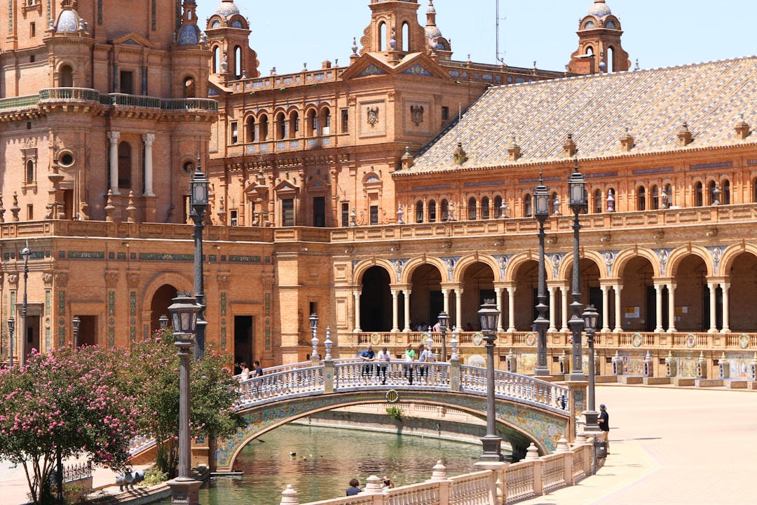 Ornate bridge over canal in front of grand building