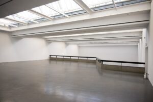 Modern art gallery interior with high ceilings and skylights