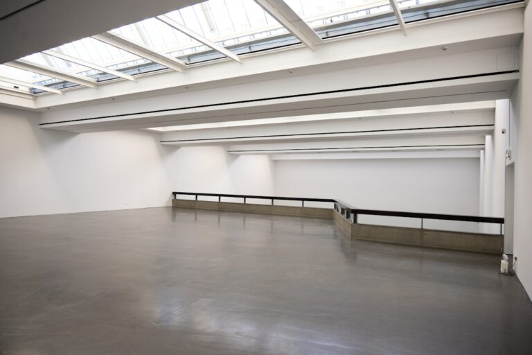 Modern art gallery interior with high ceilings and skylights