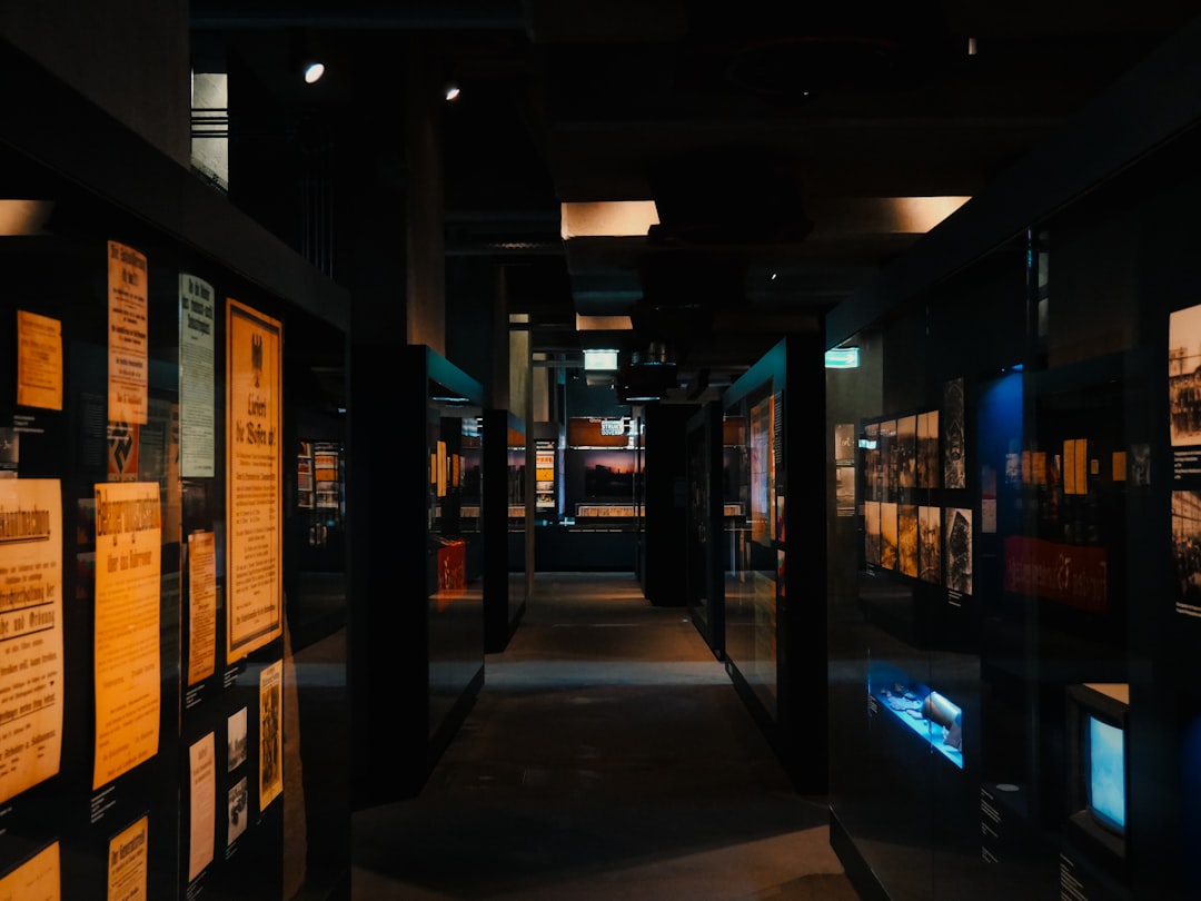 Dark museum hallway with exhibits on walls