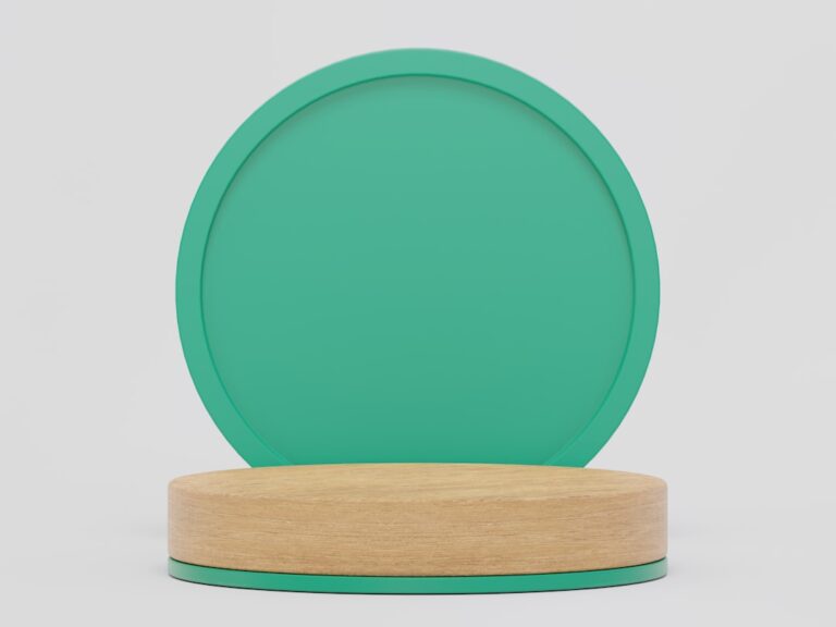 a green plate on a wooden stand on a white background