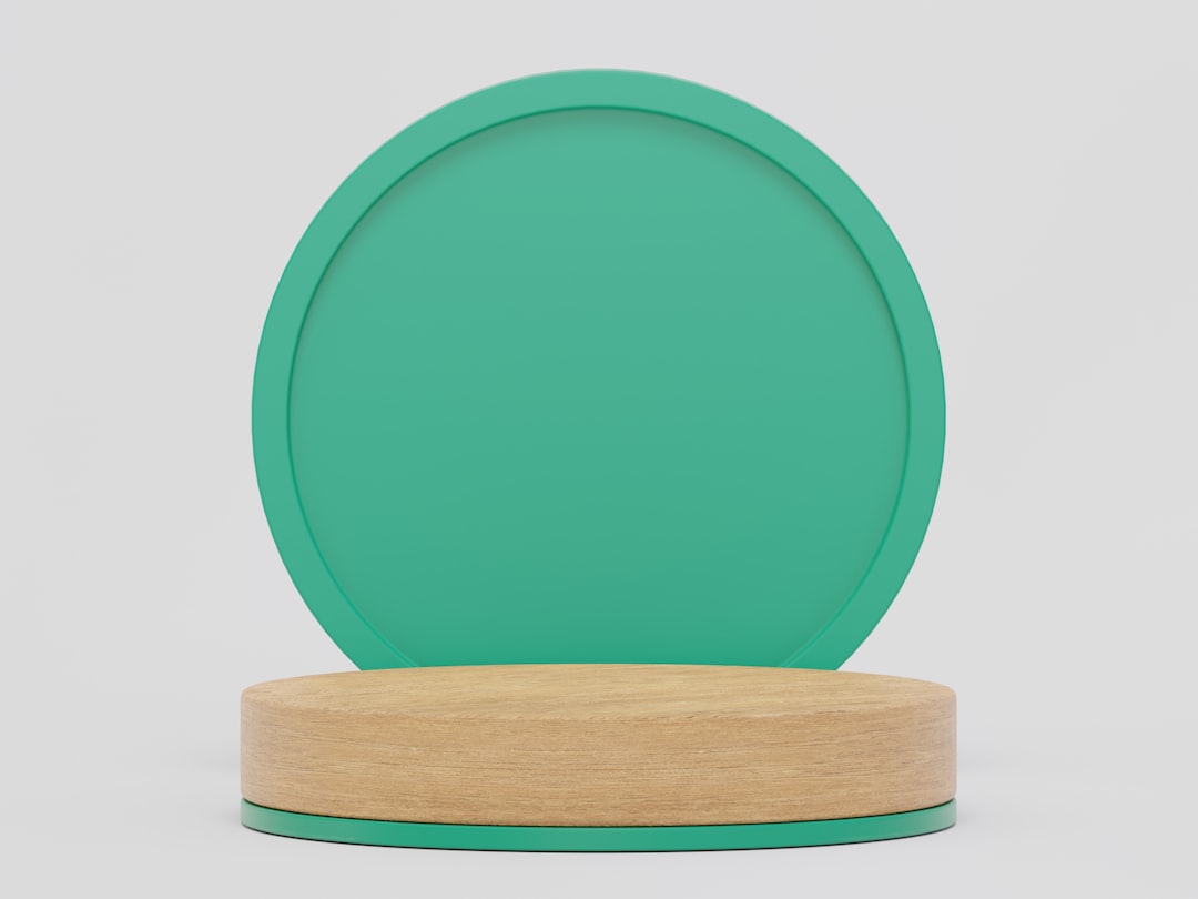 a green plate on a wooden stand on a white background