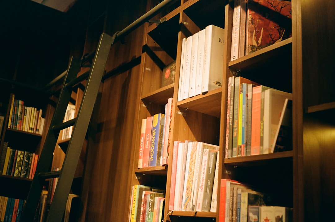A bookshelf filled with lots of books in a room