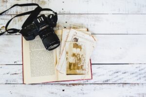 An open book with a camera on top of it