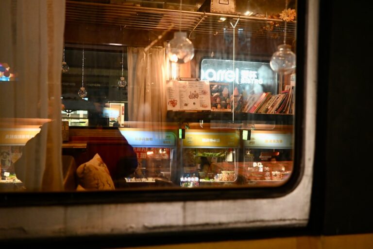 Cozy cafe interior reflected in window at night