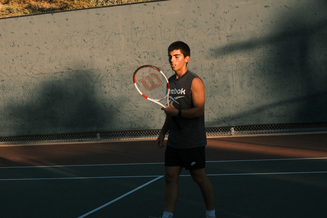 Young man holding a tennis racket on court