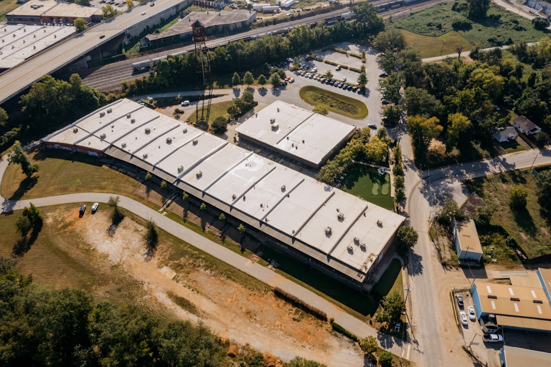 Aerial view of a modern office building with curved roof.