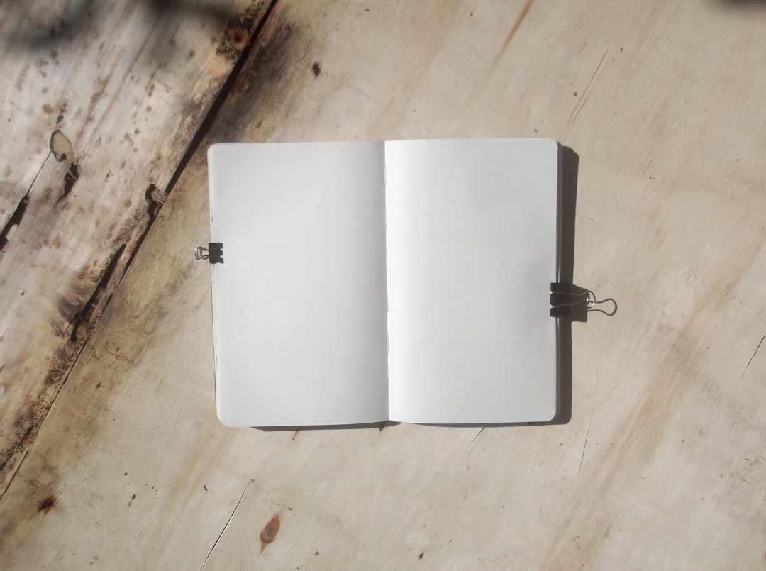 white book on brown wooden table